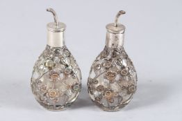A SMALL PAIR OF CHINESE DIMPLE SILVER BOTTLES. 3.5ins high.