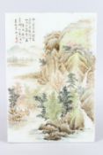 A CHINESE REPUBLICAN STYLE PORCELAIN PANEL, painted with scene of a mountainous river landscape.