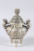 A CHINESE WHITE METAL INCENSE BURNER. 9ins high.