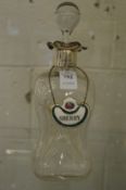 A silver mounted hour glass shaped decanter.