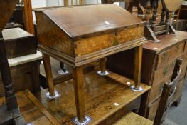 An oak and marquetry inlaid table top desk with hinged sloping front.
