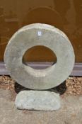 A reconstituted stone garden sculpture of circular form.