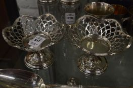 A pair of silver pierced pedestal baskets.
