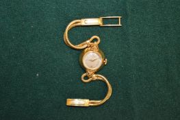 A ladies Longines 18ct gold wristwatch with 18ct gold strap.