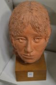 Sally Hurst, a terracotta bust of a women mounted on a wooden plinth.