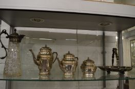 Cut glass claret jug with plated mounts, a three piece coffee and tea service and a swing handled