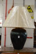 A large decorative table lamp and shade.
