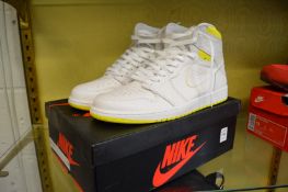 A pair of Nike Air Jordan 1 retro high OG white/dynamic yellow/black size 10, boxed.