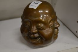 A cast bronze four faced Buddha paperweight.
