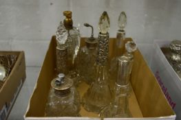 A group of cut glass and silver mounted scent bottles.