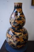 A large pair of Chinese famille noire gourd shaped vases decorated with dragons.