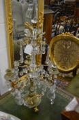 A good pair of brass and cut glass table candelabra with ornate drops and swags etc (one arm