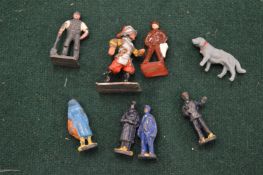 Miniature cast metal figures.