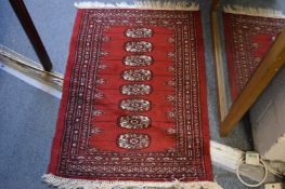 A small bokhara style rug, 90cm x 65cm.