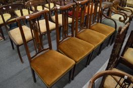 A set of four high back dining chairs.