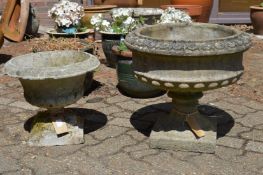 Two reconstituted stone pedestal planters.