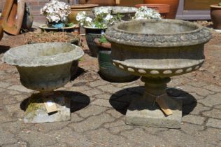 Two reconstituted stone pedestal planters.