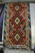 A large kilim carpet 295cm x 160cm.