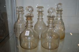 A pair of Georgian ring neck decanters and three other decanters.