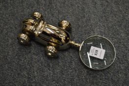 A magnifying glass the handle modelled as a racing car.