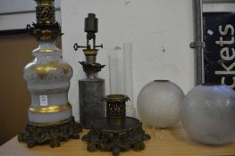 A decorative ormolu and opaque glass oil lamps (faults).