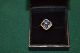 A 9ct gold diamond and sapphire ring.