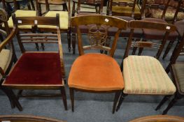 A 19th century mahogany dining chair with arms together with two other chairs.