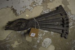 Six cast iron decorative hinge plates.