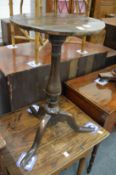 An 18th century oak tripod table.