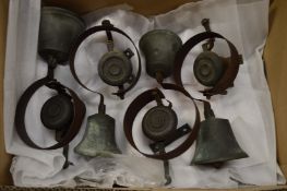 A collection of four bronze and wrought iron door bells.