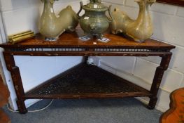 A Chinese hardwood and inlaid corner table, the lower section with carved and pierced decoration.