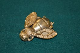 A Christian Dior gilt bee shaped brooch.