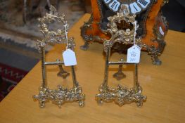A pair of ornate small brass easels.