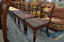 A good set of four William IV mahogany dining chairs with carved cresting rails and tie-bars,