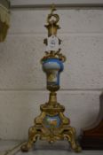 A pair of Continental porcelain and ormolu candlesticks.