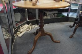 A George III mahogany circular tilt-top tripod table.