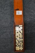 Mahogany box containing ebony and bone dominoes.