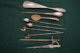 Silver handled shoe horn, button hooks and other items.