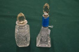 Two cut glass scent bottles with silver mounts.