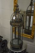 A pair of large metal and glass lanterns.