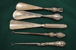 Silver handled button hooks and shoe horns.