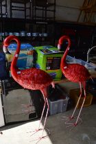 A pair of pink flamingo's.