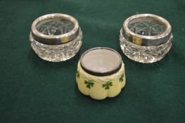 A pair of cut glass and silver mounted salts and a silver mounted porcelain salt.