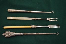 Silver handled button hooks and two pickle forks.