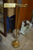 A brass adjustable floor standing lamp.