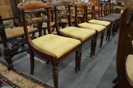 A set of four 19th century faux rosewood dining chairs with carved cresting rails and tie-bars,