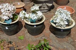 A set of three glazed plant pots.