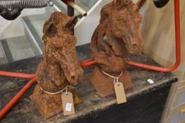 A pair of cast iron horse head gate post finials.