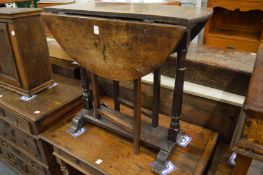 An 18th century oak small drop-leaf gate-leg occasional table.