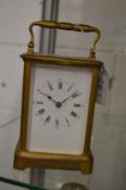 A brass carriage clock.